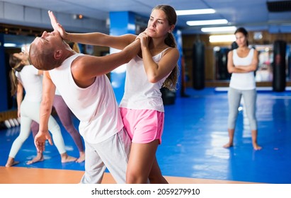 Young Lady Doing Heel Palm Chin Strike During Group Self-defence Training.