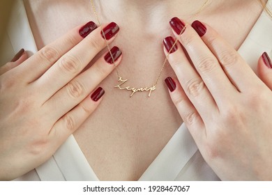 Young Lady Dressed In White Clothes And Necklace With Gold Name