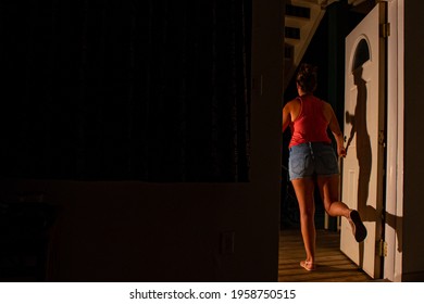 A Young Lady Has Had Enough Of Quarantine And Is About To Breach Her Obligation By Running To The Outside World Through The Front Door To Her Apartment