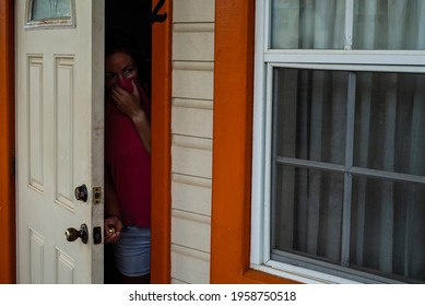 A Young Lady Has Had Enough Of Quarantine And Is About To Breach Her Obligation By Running To The Outside World Through The Front Door To Her Apartment