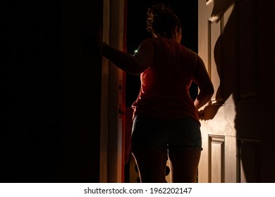 A Young Lady Has Had Enough Of Quarantine And Is About To Breach Her Obligation By Running To The Outside World Through The Front Door To Her Apartment