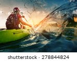Young lady paddling hard the kayak with lots of splashes