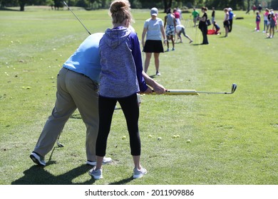 A Young Lady Receives Golf Instruction