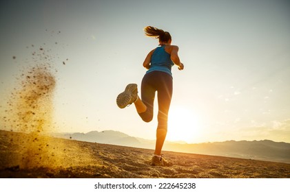 Young Lady Running In The Desert At Sunset