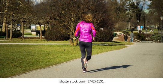 Young Lady Running Ina Central Park During Sunset