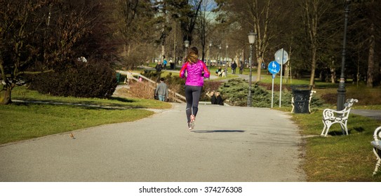 Young Lady Running Ina Central Park During Sunset