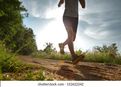 Young lady running on a rural road - Shutterstock ID 152622242