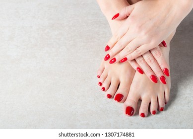 Young lady is showing her red manicure nails, light background, copy space