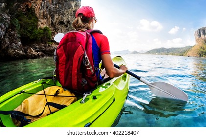 Young lady sits in the kayak with a paddle in the sea - Powered by Shutterstock