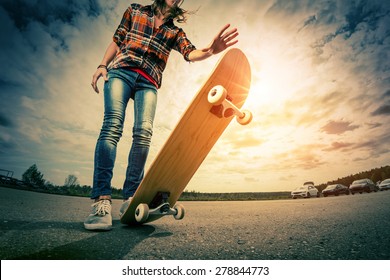 Young lady with skateboard - Powered by Shutterstock