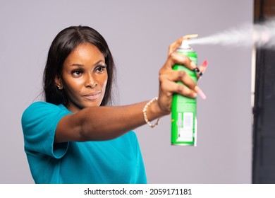 Young Lady Spraying An Insecticide