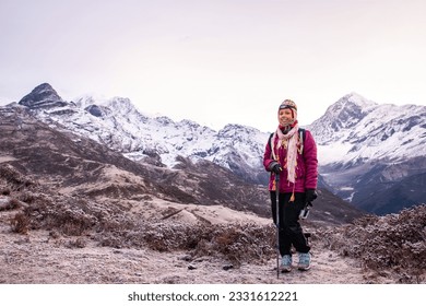 Young lady standing in front of Mt.Kanchenjungha range at Dzongri top, Sikkim. - Powered by Shutterstock