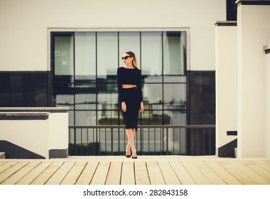 Young Lady Standing Near The Business Center. Looking Away. Copy Space