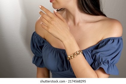 Young Lady With Thick Gold Chain Bracelet On Her Arm