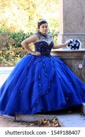 Young Lady Wearing Blue 18th Century Bridesmaid Dress And Silver Tiara And Blue And White Bouquets Pose For Photos In Prospect Park In Brooklyn Ny October 3 2019