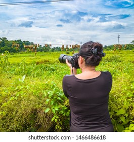 Young Lady Wildlife Photographer Taking Photos With Zoom Lens.