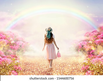 Young lady woman in romantic pink dress, retro hat, bag walking along rose garden path leading to fabulous rainbow unicorn house, flecks of sunlight on road. Tranquil fantasy scene, fairytale hills.