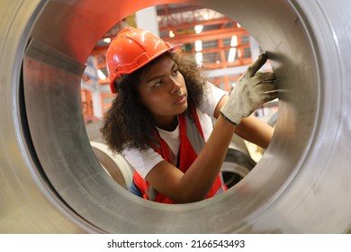 the young lady worker operate the metal machine tool in pipe factory or machinery industry - Shutterstock ID 2166543493
