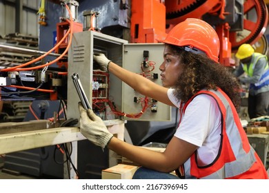 the young lady worker operate or repair electric distribution board circuit of the metal machine tool in factory or machinery industry - Shutterstock ID 2167396945