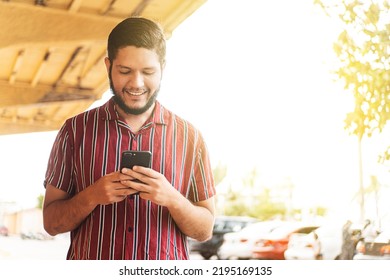 Young Latin American Man Using A Mobile Phone.