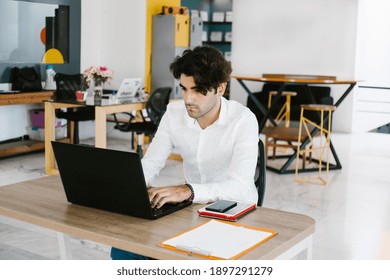 Young Latin American Man Working At Computer At Office In Mexico City