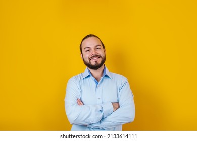 young latin bearded business man wearing formal clothes smiling at camera in yellow background in Mexico Latin America