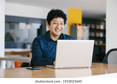 Young latin businessman working at his desk at office in Mexico city - Powered by Shutterstock