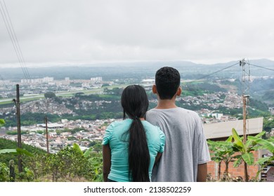 Young Latin Couple, Country People Looking Towards The City Of Pereira-Colombia. University Students Dreaming Of The Future And Thinking About Their Life Project. Concept Of Prosperity.