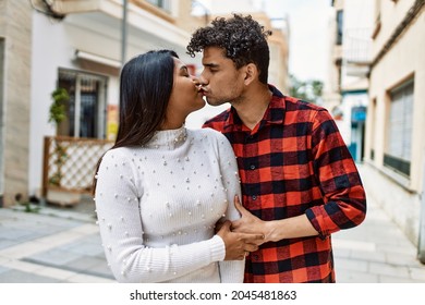 Young Latin Couple Kissing And Hugging At The City.