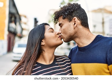 Young Latin Couple Kissing And Hugging At The City.