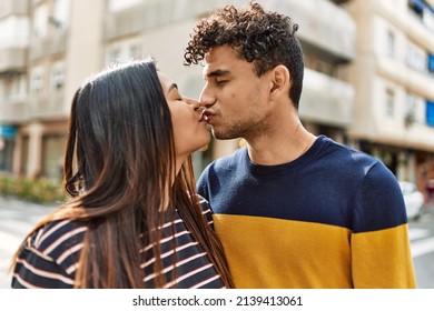 Young Latin Couple Kissing And Hugging At The City.