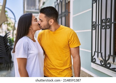 Young Latin Couple Kissing And Hugging At The City.