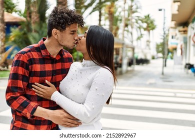 Young Latin Couple Kissing And Hugging At The City.