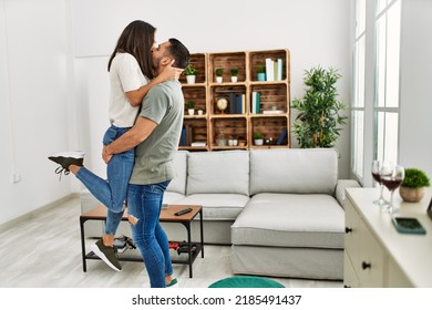 Young Latin Couple Kissing And Hugging At Home.