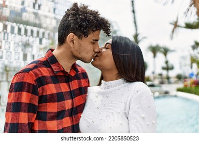 Young Latin Couple Kissing And Hugging At The City.