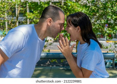 A Young Latin Couple Or Married Couple Having A Heated Fight In The Street. Concept Of Fight, Heartbreak, Couple, Discussion.