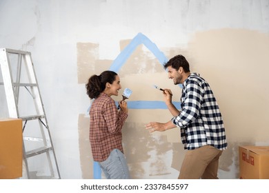 Young latin couple painting home with smiling together. New home concept. - Powered by Shutterstock