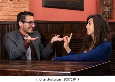 young latin couple in a restaurant having an argument - Powered by Shutterstock