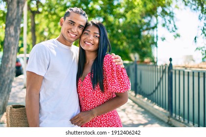 Young Latin Couple Smiling Happy And Hugging At The Park.