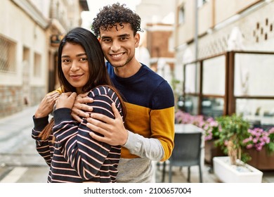 Young Latin Couple Smiling Happy And Hugging At The City.