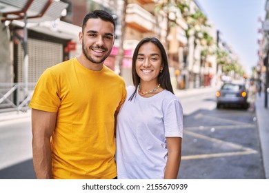 Young latin couple smiling happy and hugging standing at the city. - Shutterstock ID 2155670939