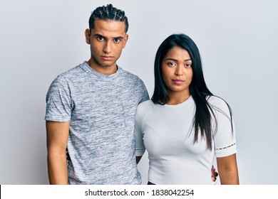 Young Latin Couple Wearing Casual Clothes Skeptic And Nervous, Frowning Upset Because Of Problem. Negative Person. 