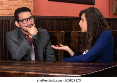 Young Latin Couple Woman Nagging Her Boyfriend In A Restaurant