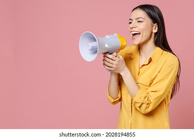 Young latin cute smiling beautiful attractive expressive excited woman 20s wearing yellow shirt screaming in megaphone shout aside hot news isolated on pastel pink color background studio portrait - Powered by Shutterstock