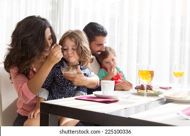 Young Latin Family Having Breakfast With Kids