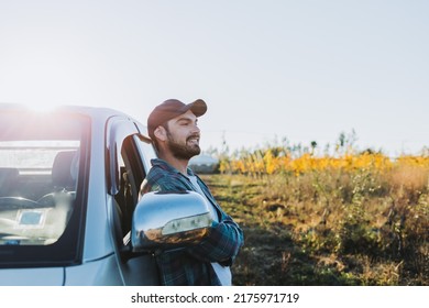 Young latin farmer man leaning on his pickup truck and looking at his plantations.  - Shutterstock ID 2175971719