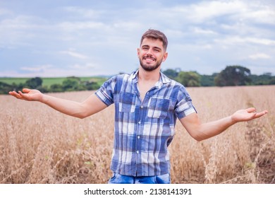 Young Latin Farmer Working On Wheat Field Pointing To Free Space For Text