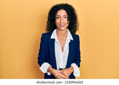 Young latin girl wearing business clothes looking positive and happy standing and smiling with a confident smile showing teeth  - Shutterstock ID 2150956363