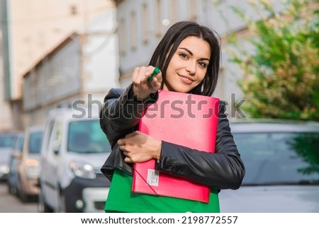 young latin hispanic student girl with books on the street