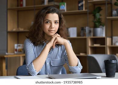 Young Latin Hispanic Teen Girl College Student Or Intern Sitting At Table With Laptop In Campus Looking At Camera. University Online Classes, Distance Study, Remote Virtual Learning Concept, Portrait